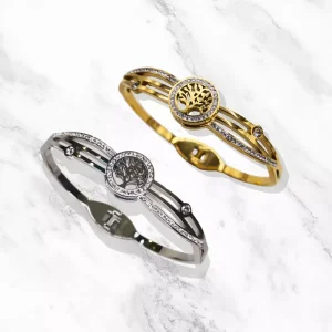 Bracelet Nila doré ou argenté ovale orné d'un arbre de vie et de petits diamants étincelants.